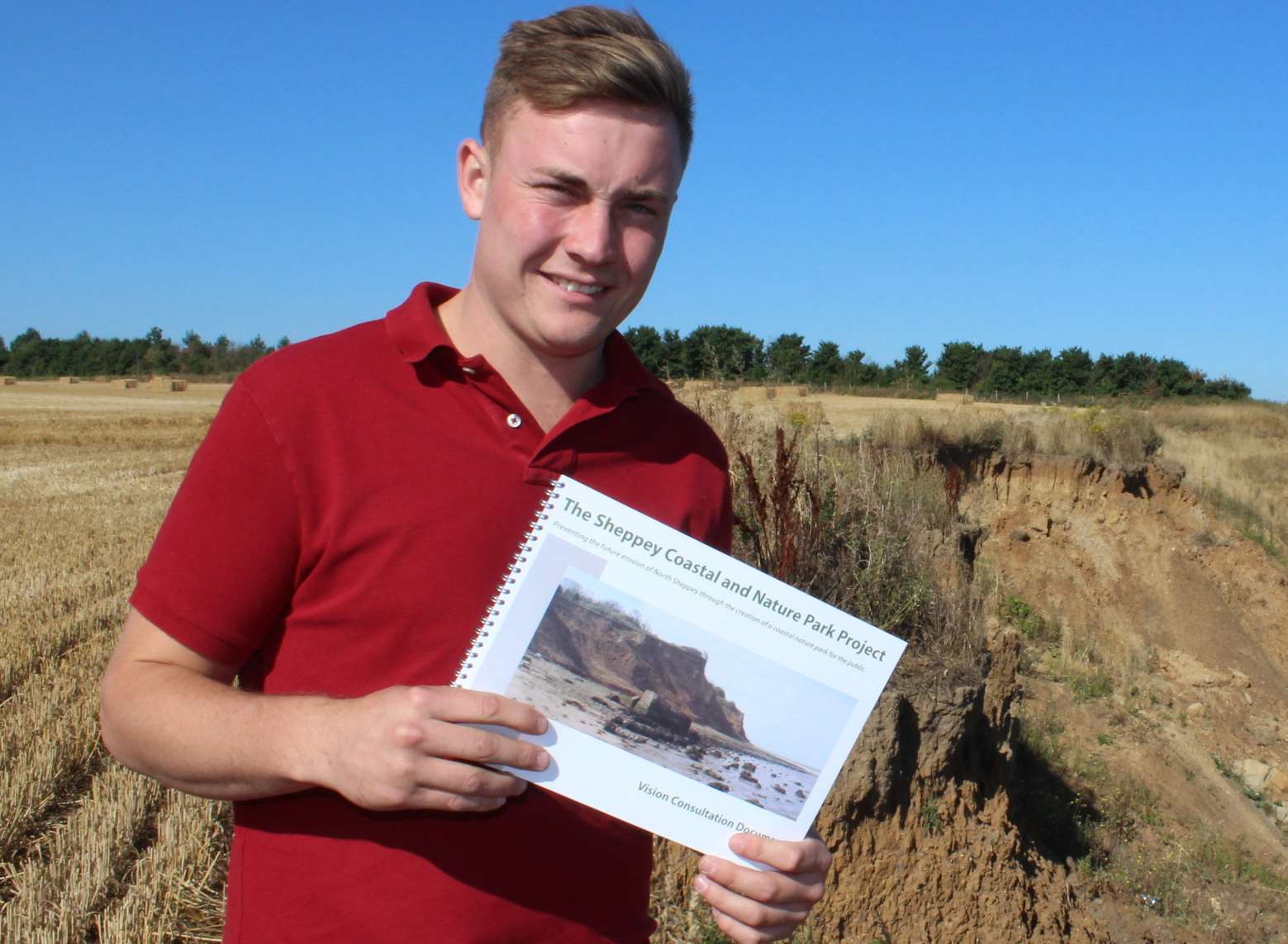 James Attwood on the cliffs at Eastchurch with a copy of his consultation document