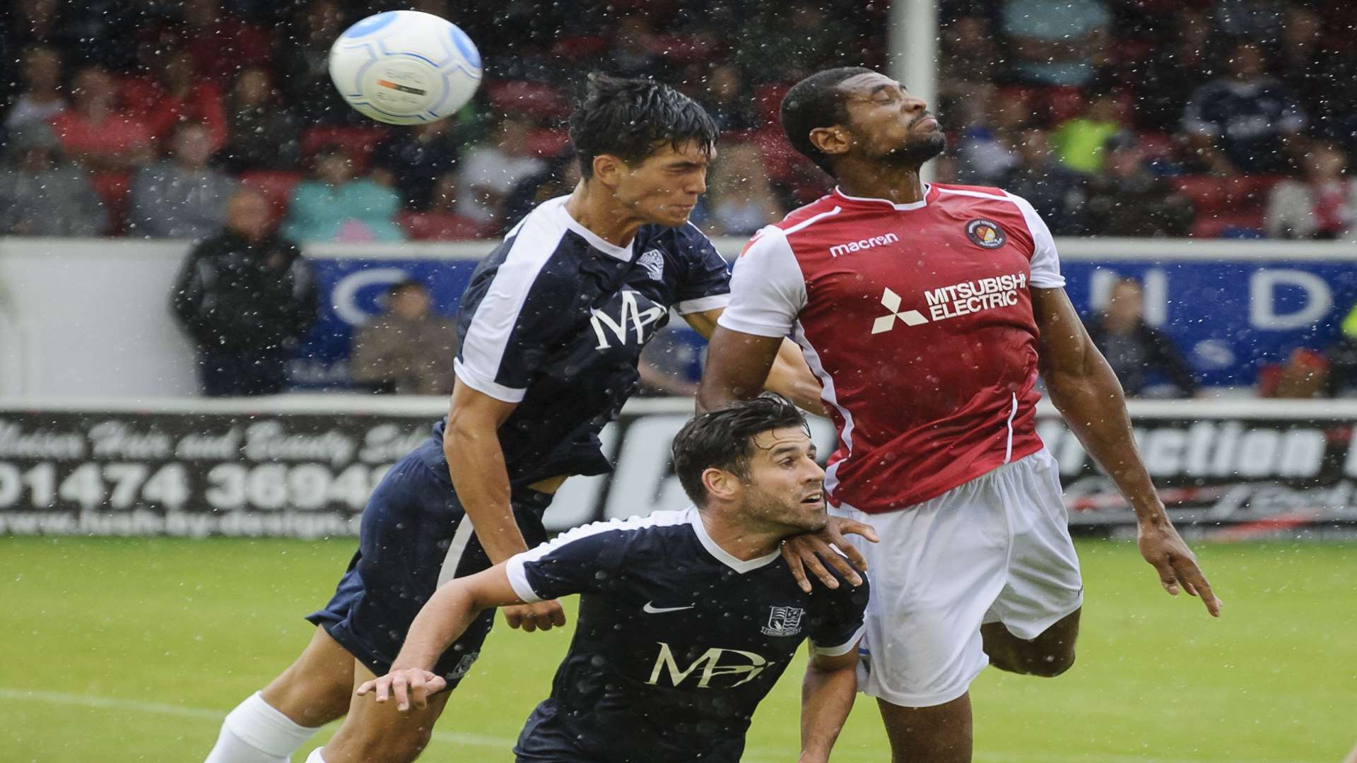 Danny Mills up for a header as the rain falls Picture: Andy Payton