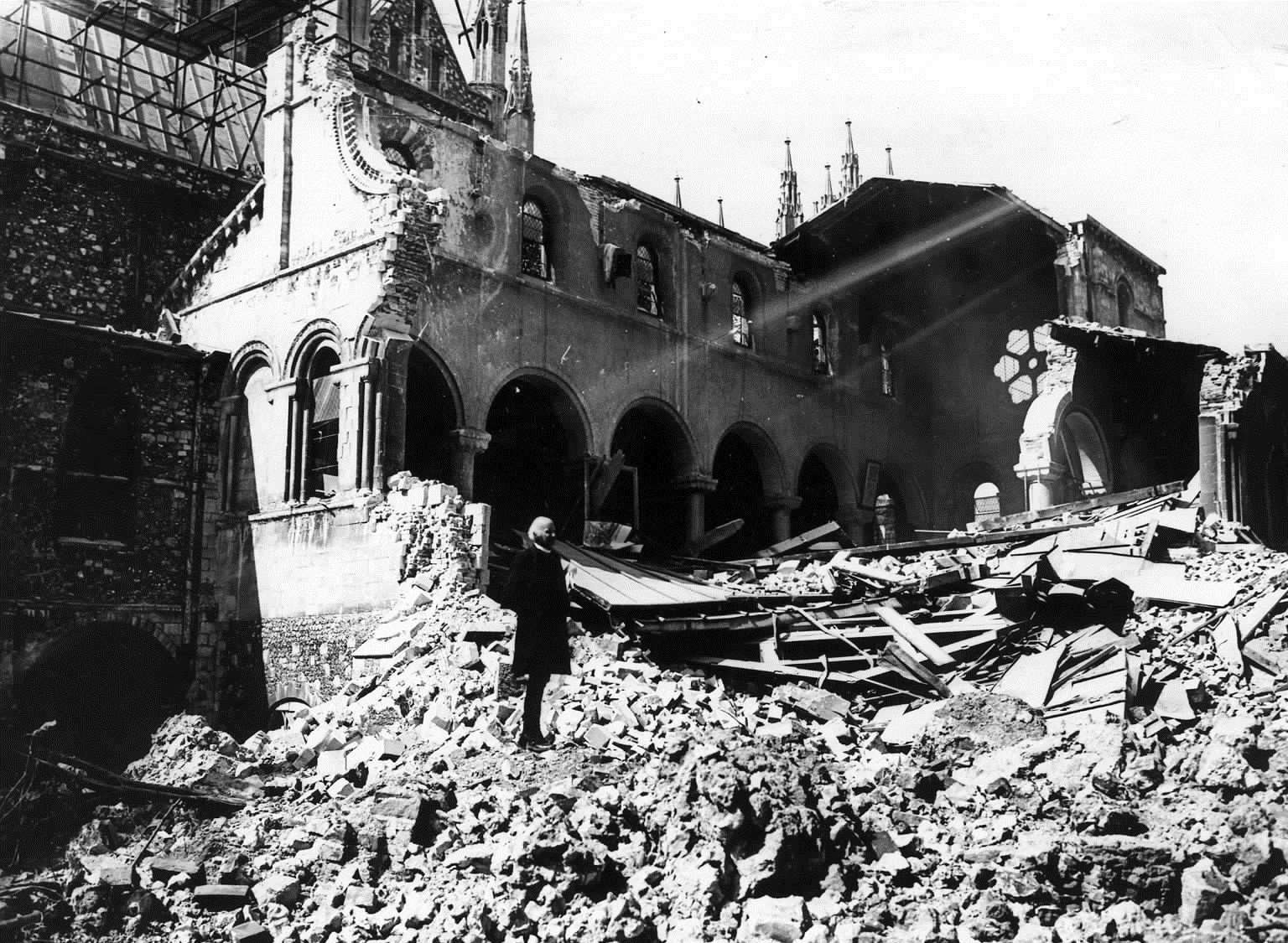 The Dean of Canterbury, Dr Hewlett Johnson, surveys the ruins of the bombed Cathedral