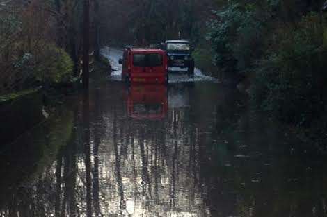 Vehicles battle flood water in Birling this afternoon