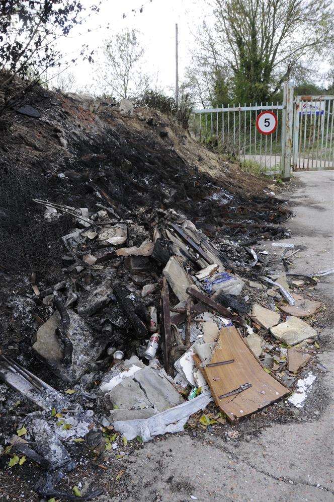 The burnt-out pile of tyres and rubbish