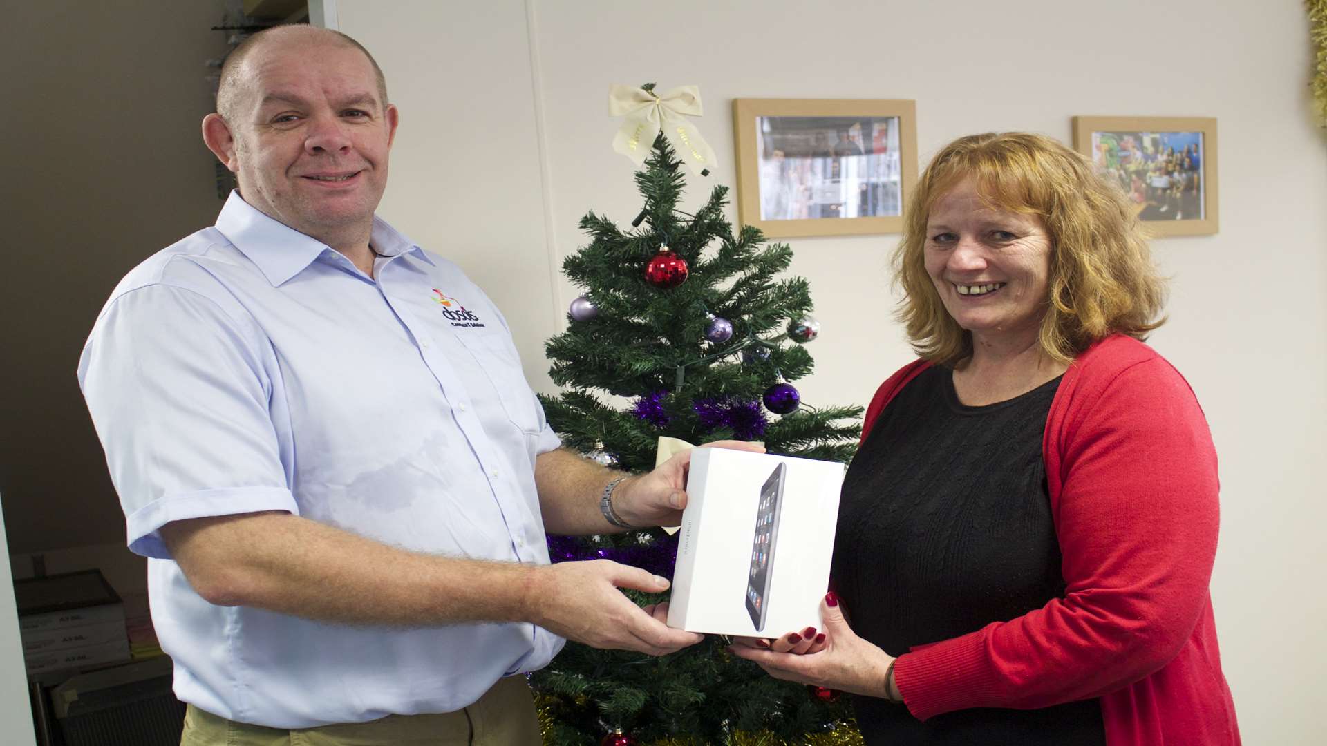 Ian Wilkinson, managing director at Absols Complete IT Solutions, presents the iPad to Carol Bentall, chief executive, Young Kent.