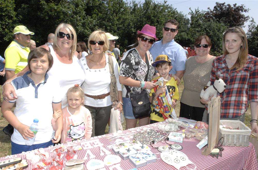 Customers and helpers around one of the stalls at the Minster Village Fayre