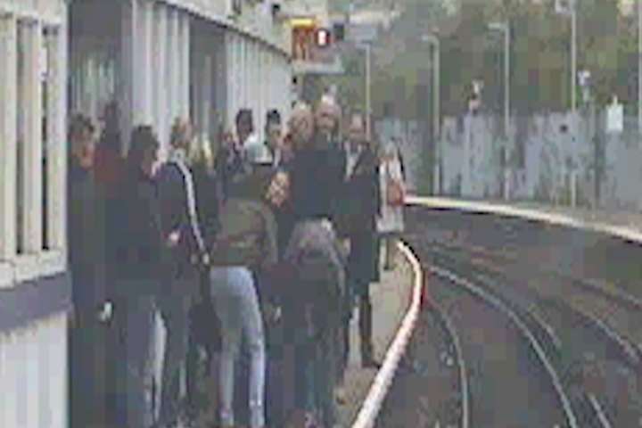 Passengers tend to the woman after her track ordeal. Picture: Southeastern