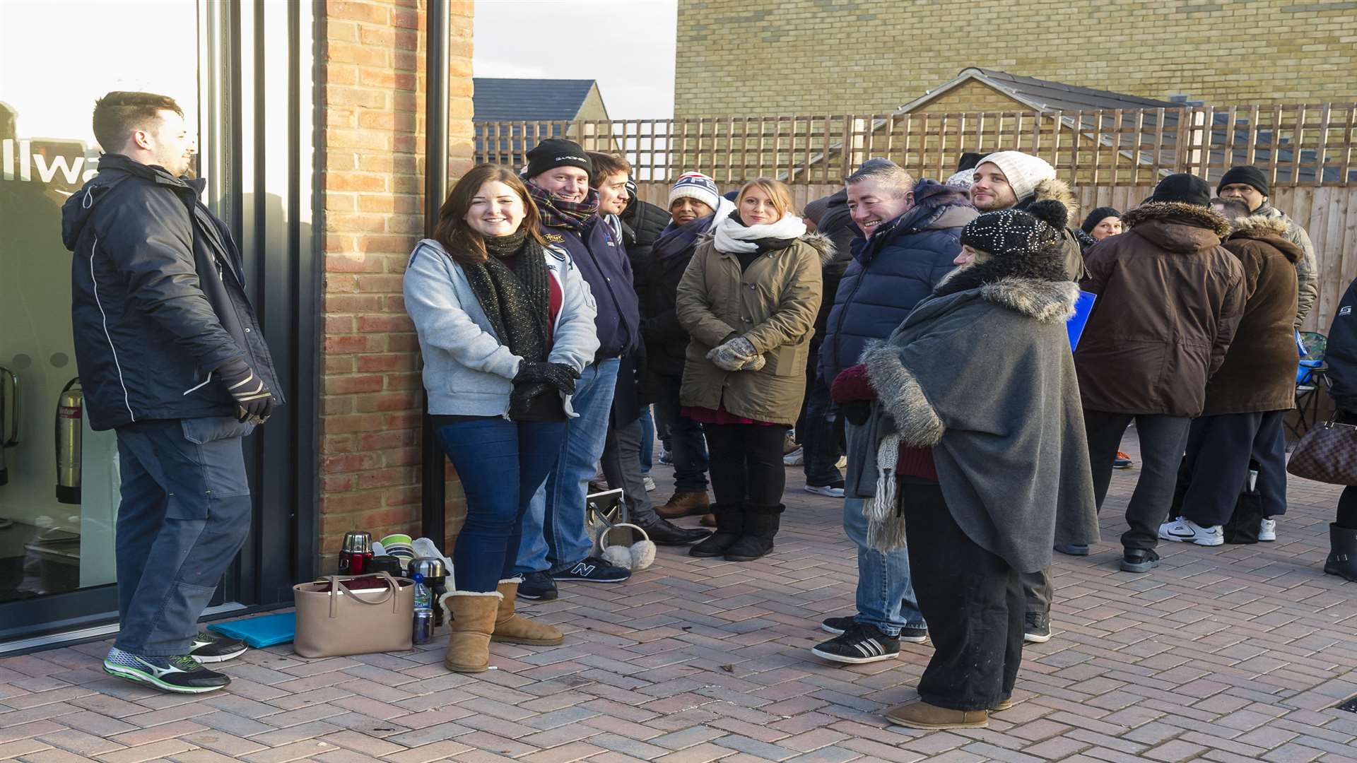 People queue outside the Bellway Homes offices at their Priory Mill site