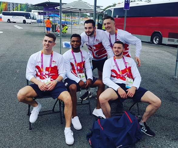 Pegasus gymnasts Courtney Tulloch and James Hall, centre, arrive in Australia with their England team-mates