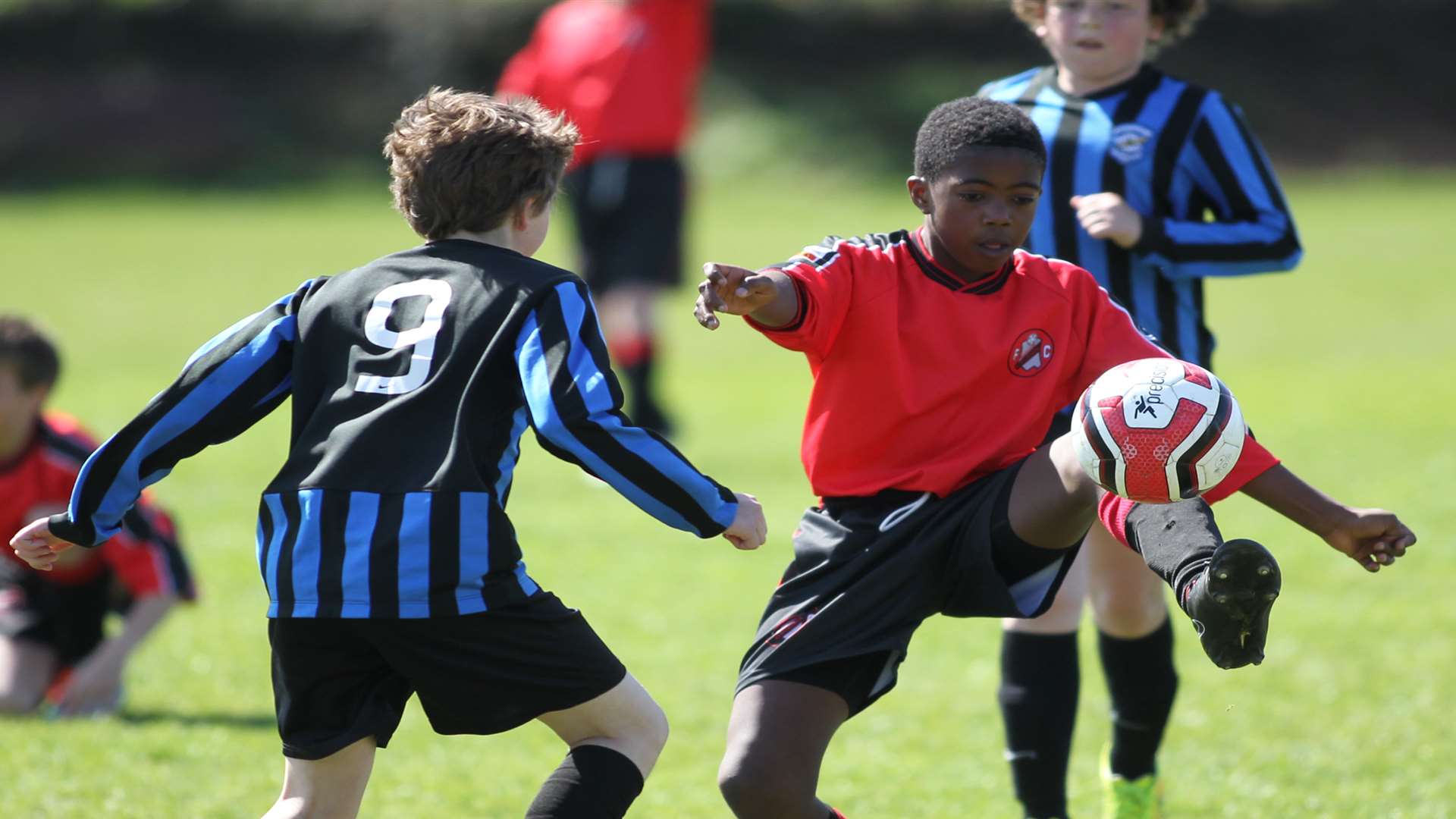 Rainham Kenilworth Colts under-11s, in red, show good close control against Fairview Rangers in Division 1 Picture: John Westhrop
