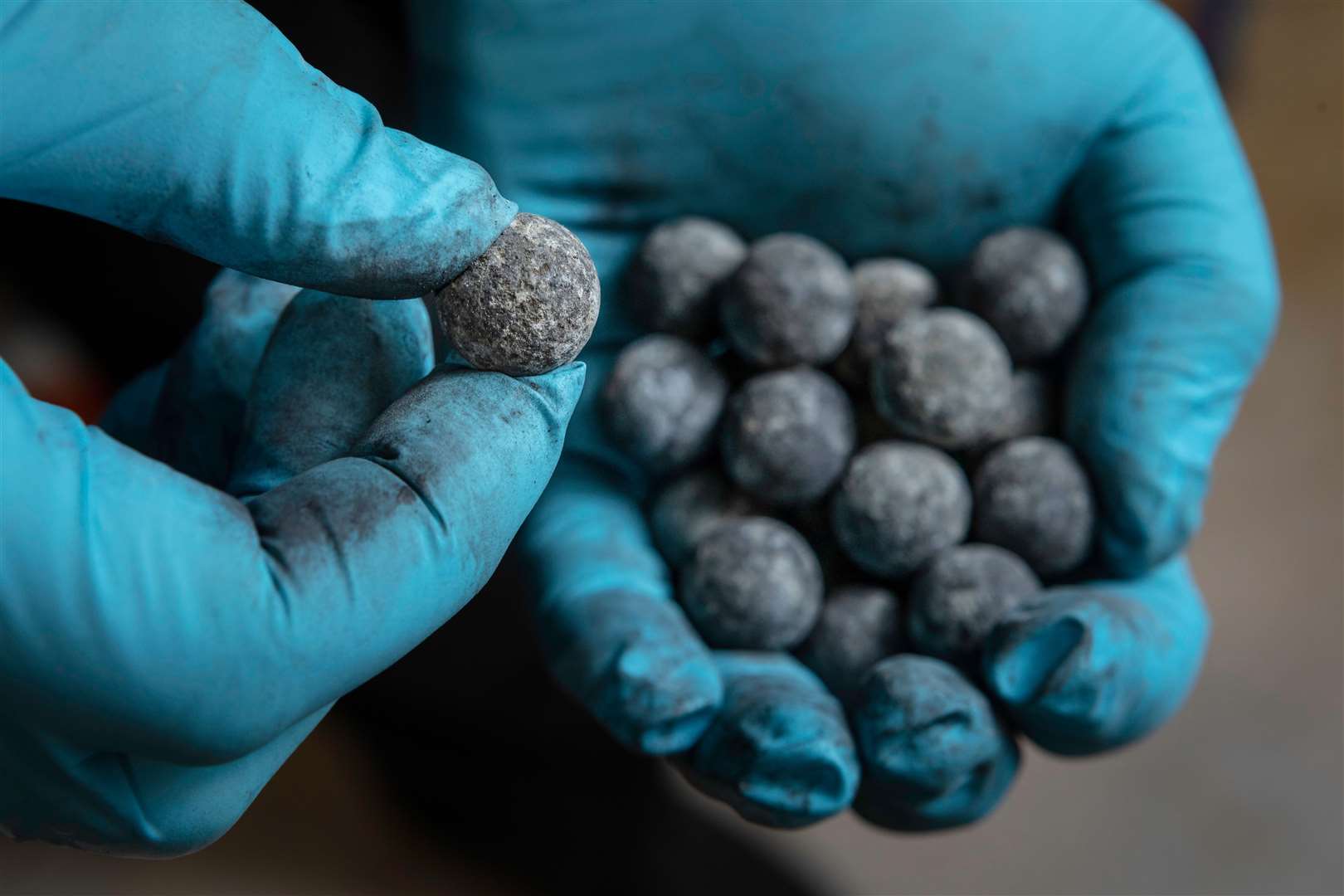 Volunteers helping to conserve items recovered from the wreck of HMS Invincible in Poole, Dorset – including balls of lead shot. Picture: Christopher Ison/National Museum of the Royal Navy