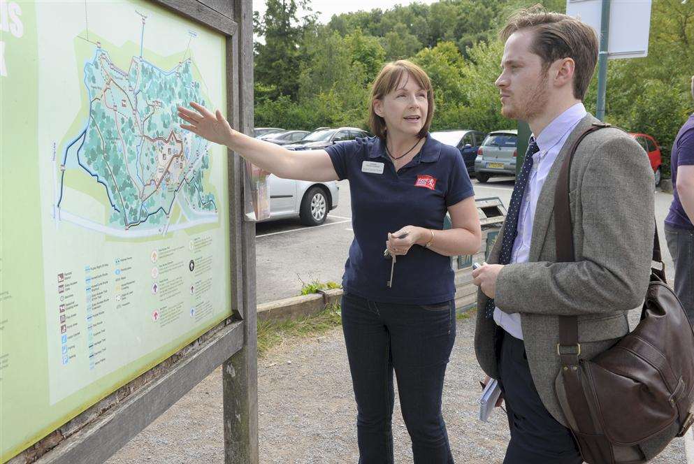 Operations manager Amanda Dunk shows Alex Matthews a map of the park