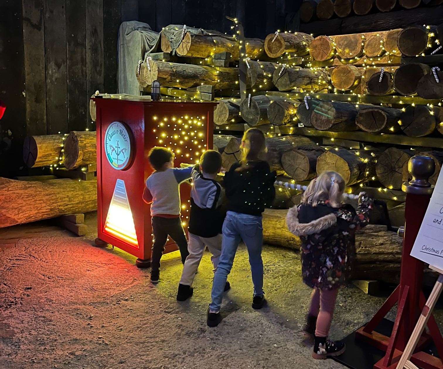 Children turn a wheel to produce Christmas spirit and power up the Claus-o-meter