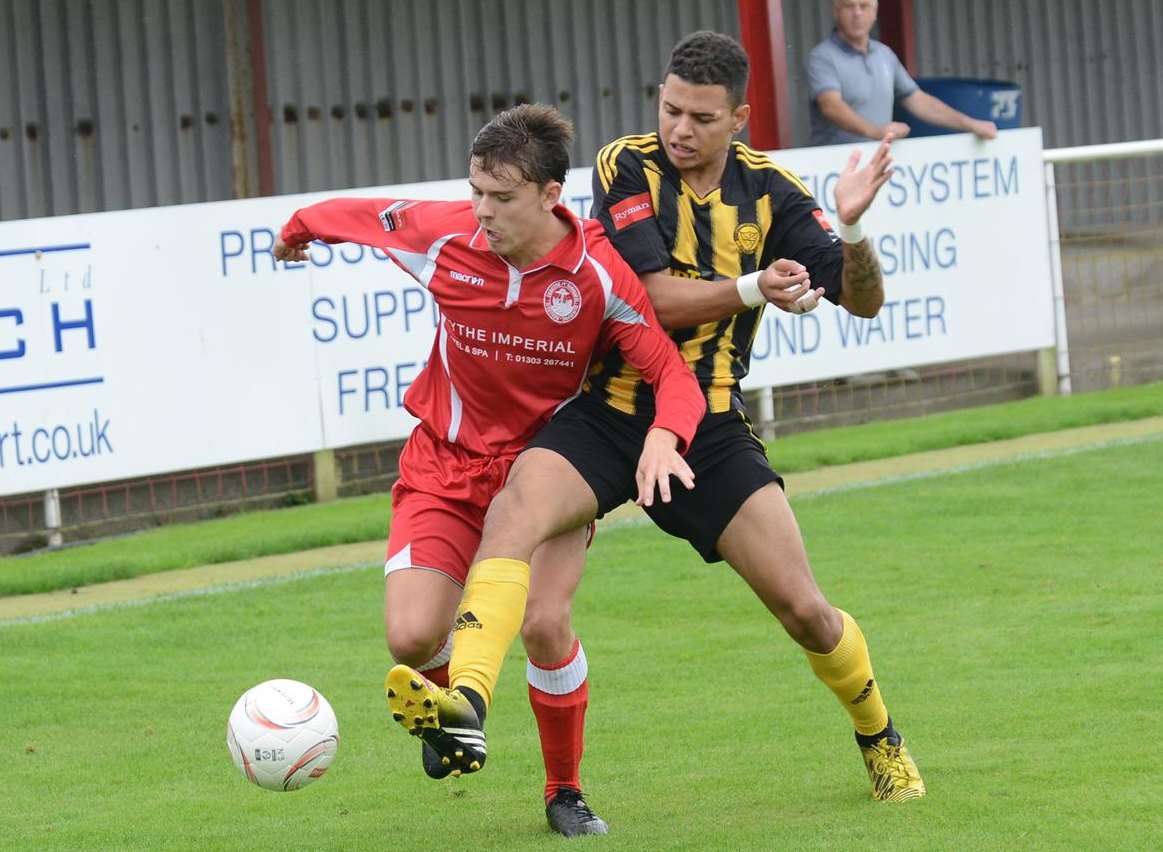 Hythe's Dave Pilcher (left) battles for possession against Merstham Picture: Gary Browne
