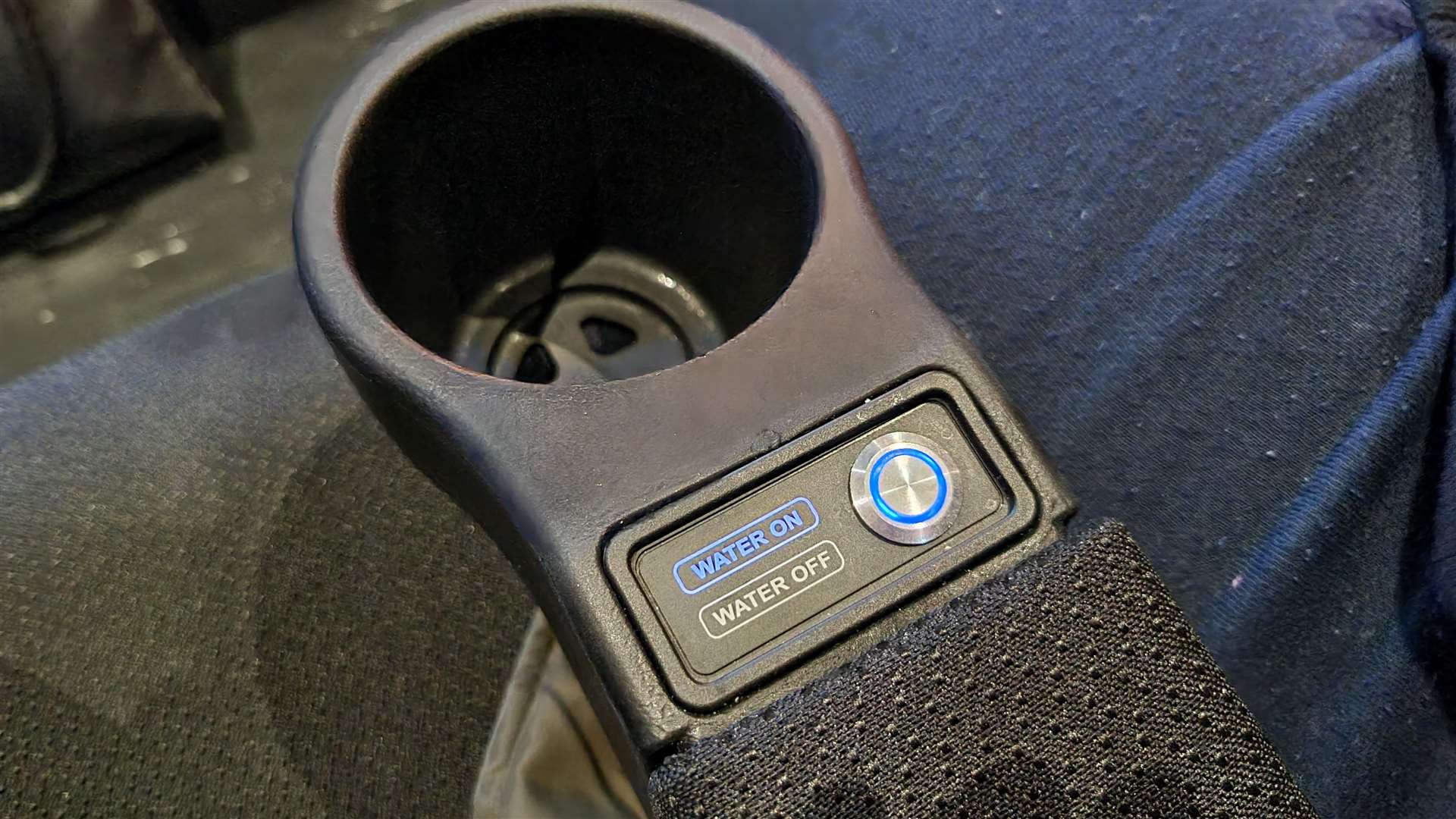 You can turn the water off with a button on the armrest
