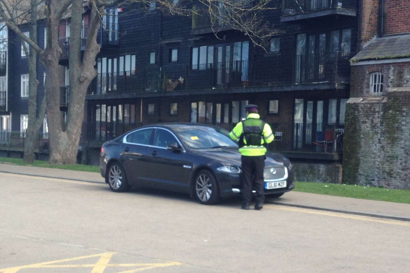 A parking attendant slaps a ticket on Mr Carmichael's Jaguar
