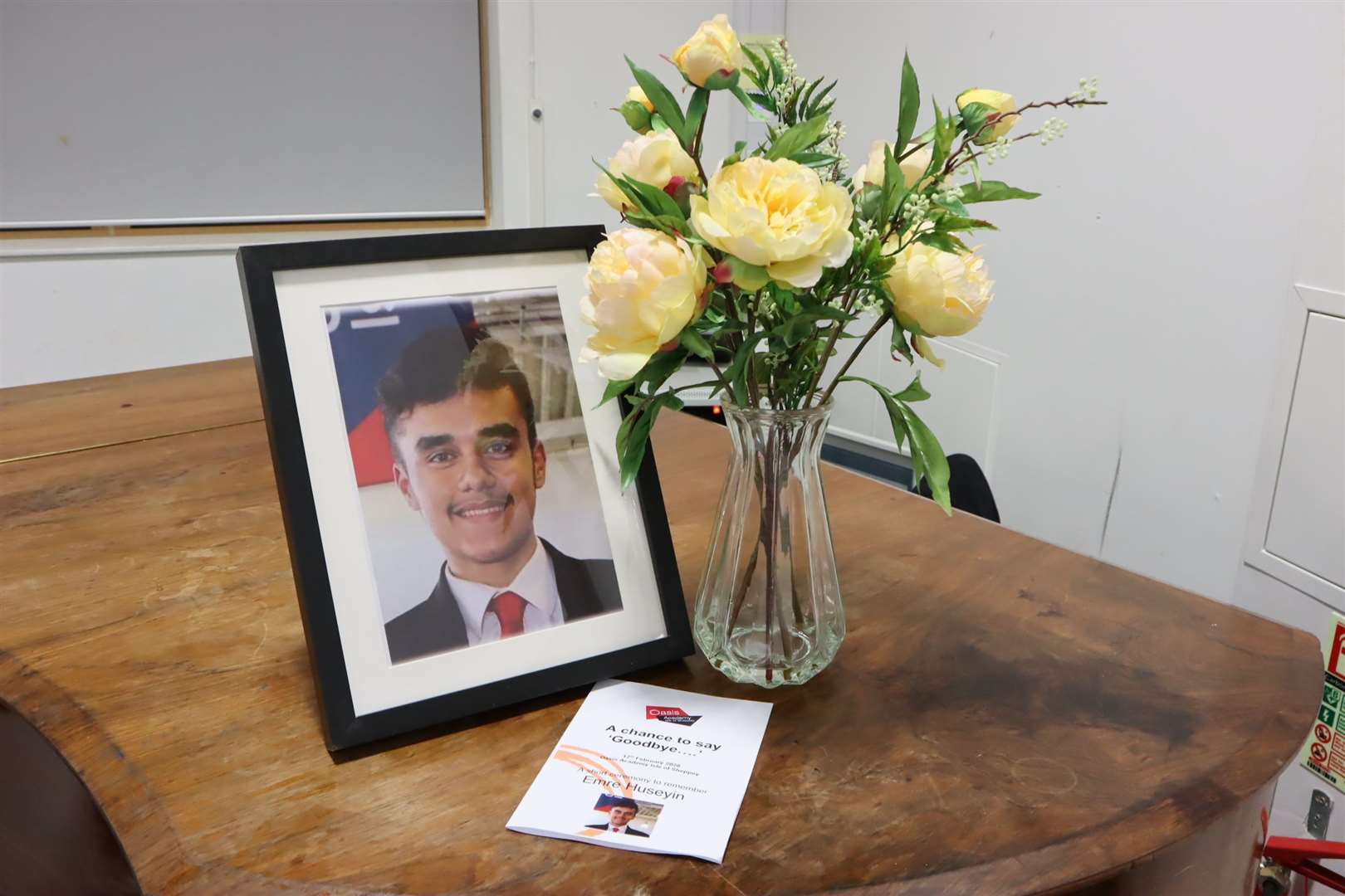 Flowers, portrait and programme for the ceremony to remember Emre Huseyin at the Oasis Academy, Sheppey