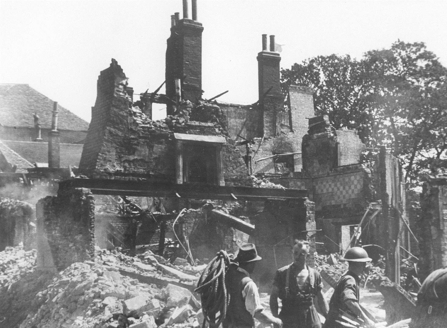 Service personnel try to find survivors in the debris that once was Dashwood's toy shop