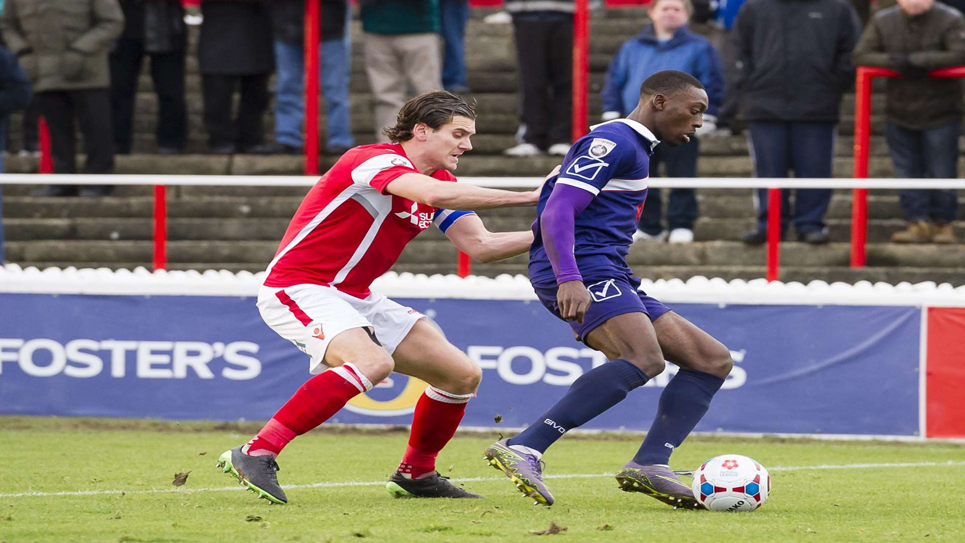 Margate's Freddie Ladapo shields the ball from Ebbsfleet captain Tom Bonner Picture: Andy Payton