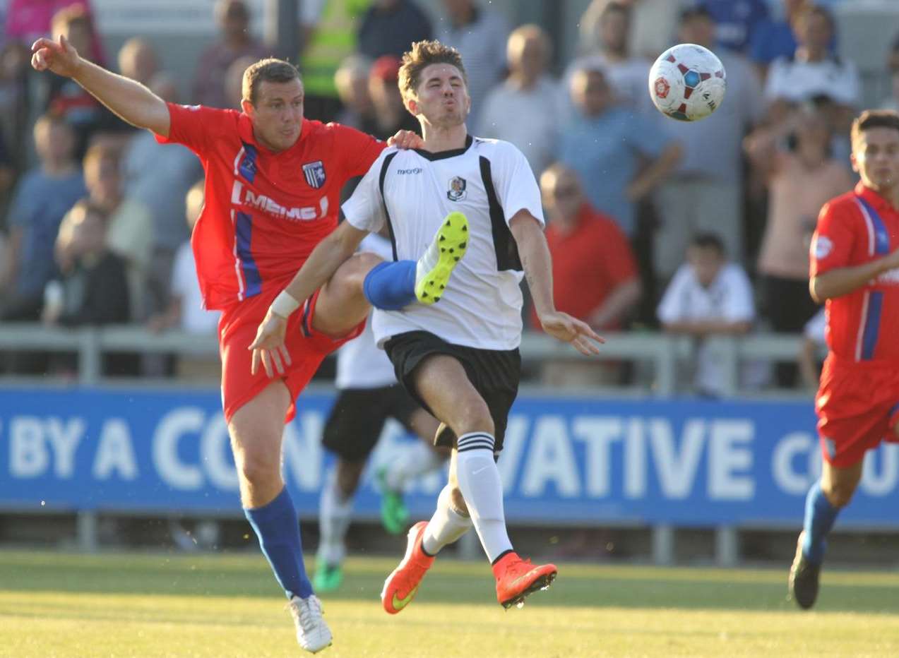 Gillingham's Gary Borrowdale wins the ball from Dartford's Tom Derry Pic: John Westhrop