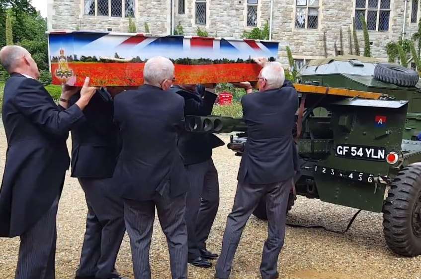 Pall bearers lift Albert Figg's special coffin from the gun carrier