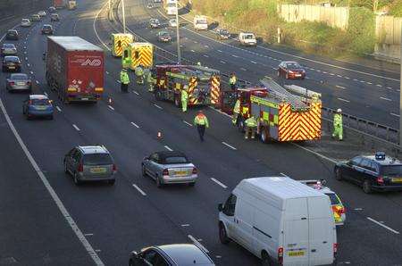 Fire crews cut two people from a crashed car on the M20. Picture: Martin Apps