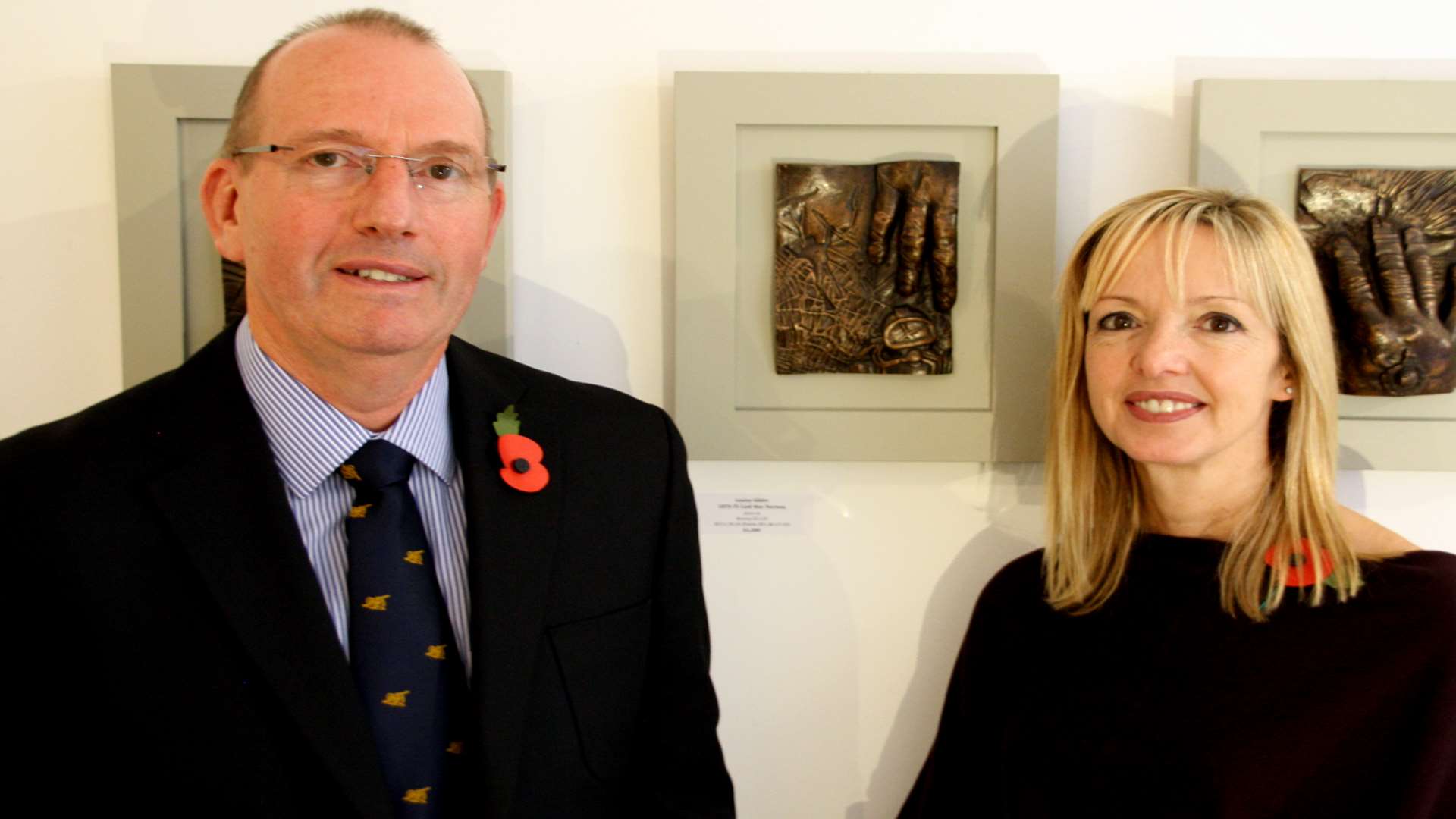 Lawrence Kidman and artist Louise Giblin in front of his hand plaque