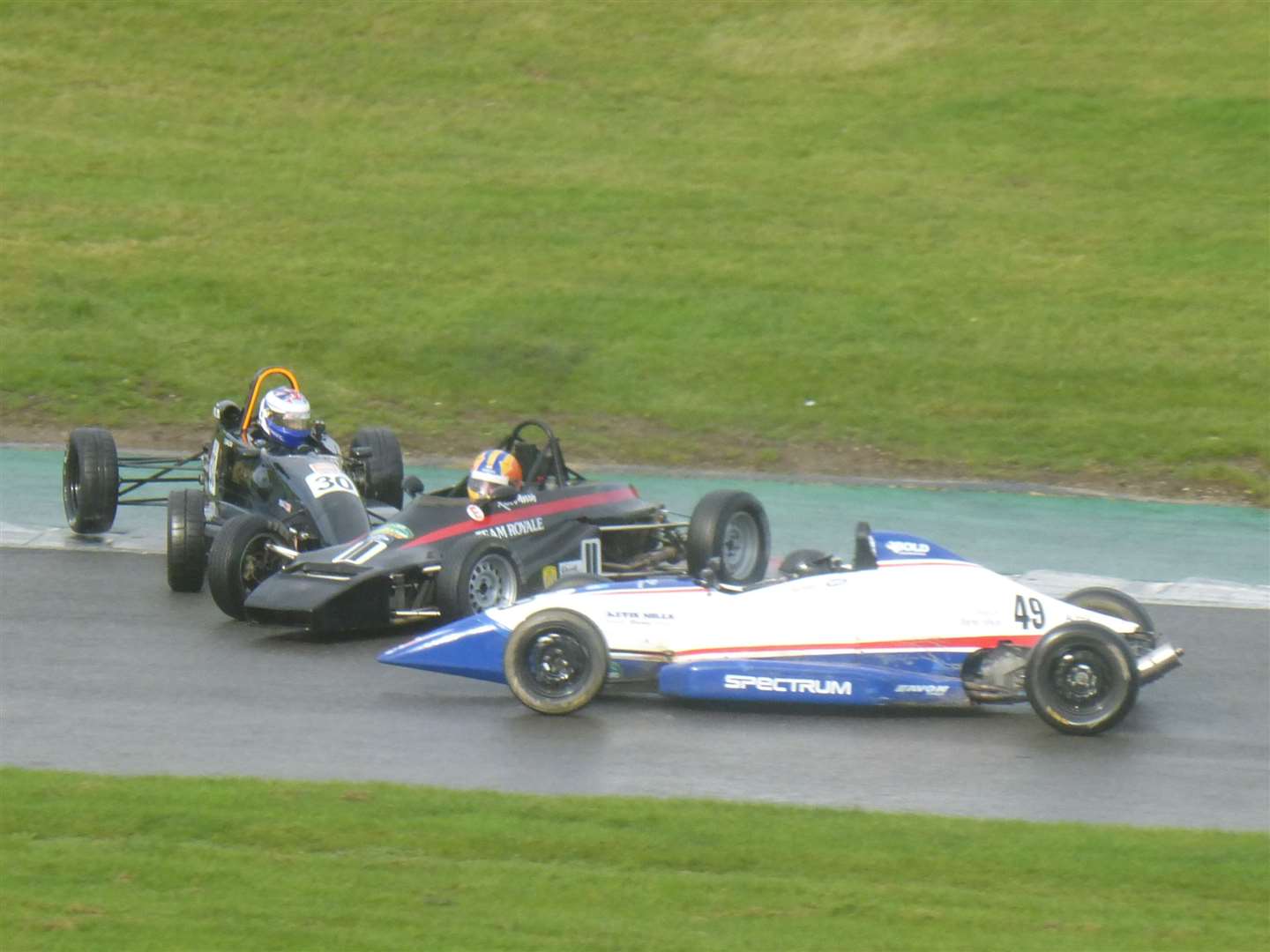 Drama at Graham Hill Bend in semi final one involving Formula Ford veteran Rick Morris, centre, and W Series competitor Megan Gilkes