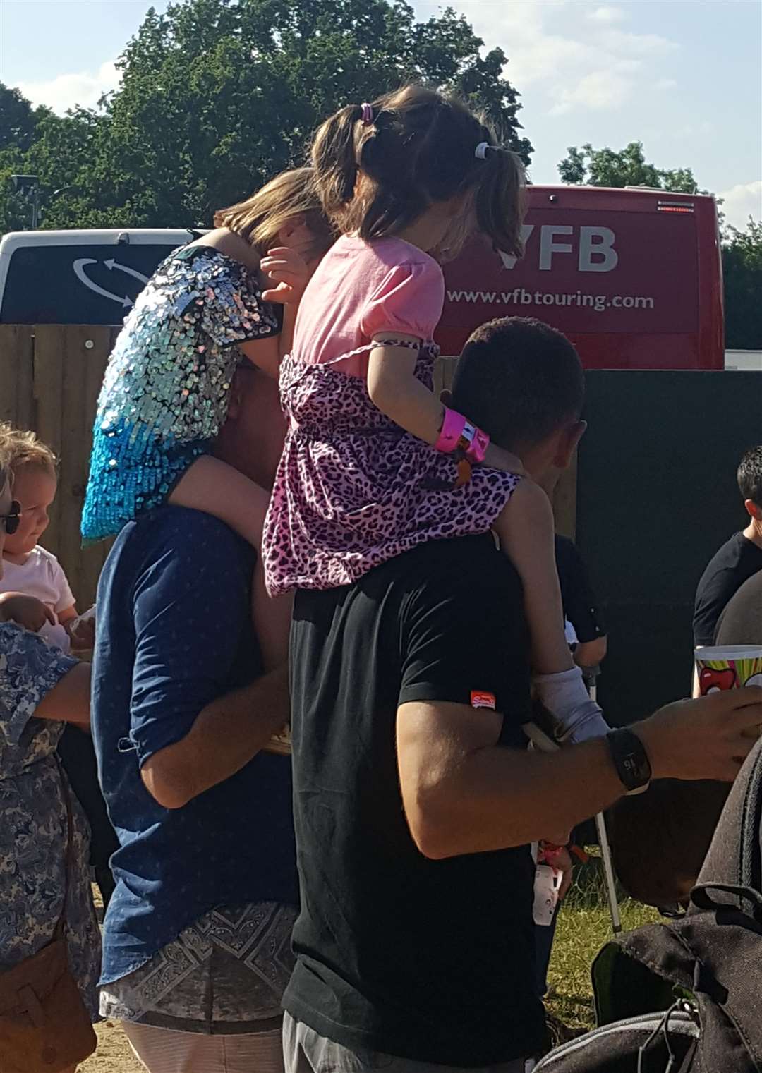 Little festivalgoers dress for the occasion and ride high on Dad's shoulders at Black Deer