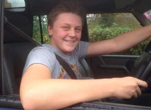 Ben at the wheel of a Land Rover, aged 13