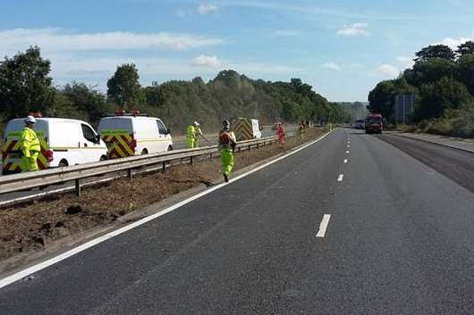 Workers clearing vegetation on the M20