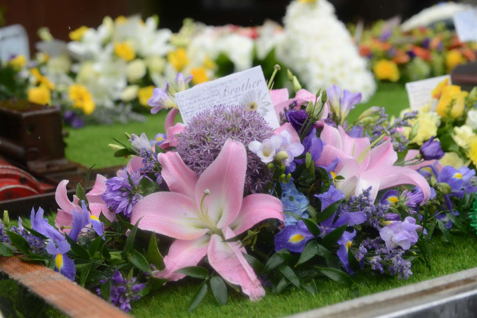 Flowers and tributes to grandfather Roy Blackman at his funeral