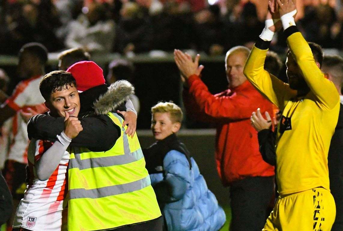 Sheppey's Frankie Morgan gives the thumbs-up as he is embraced after The Ites’ penalty shoot-out win against Billericay on Tuesday which sets up FA Cup First-Round home fixture with Walsall. Picture: Marc Richards
