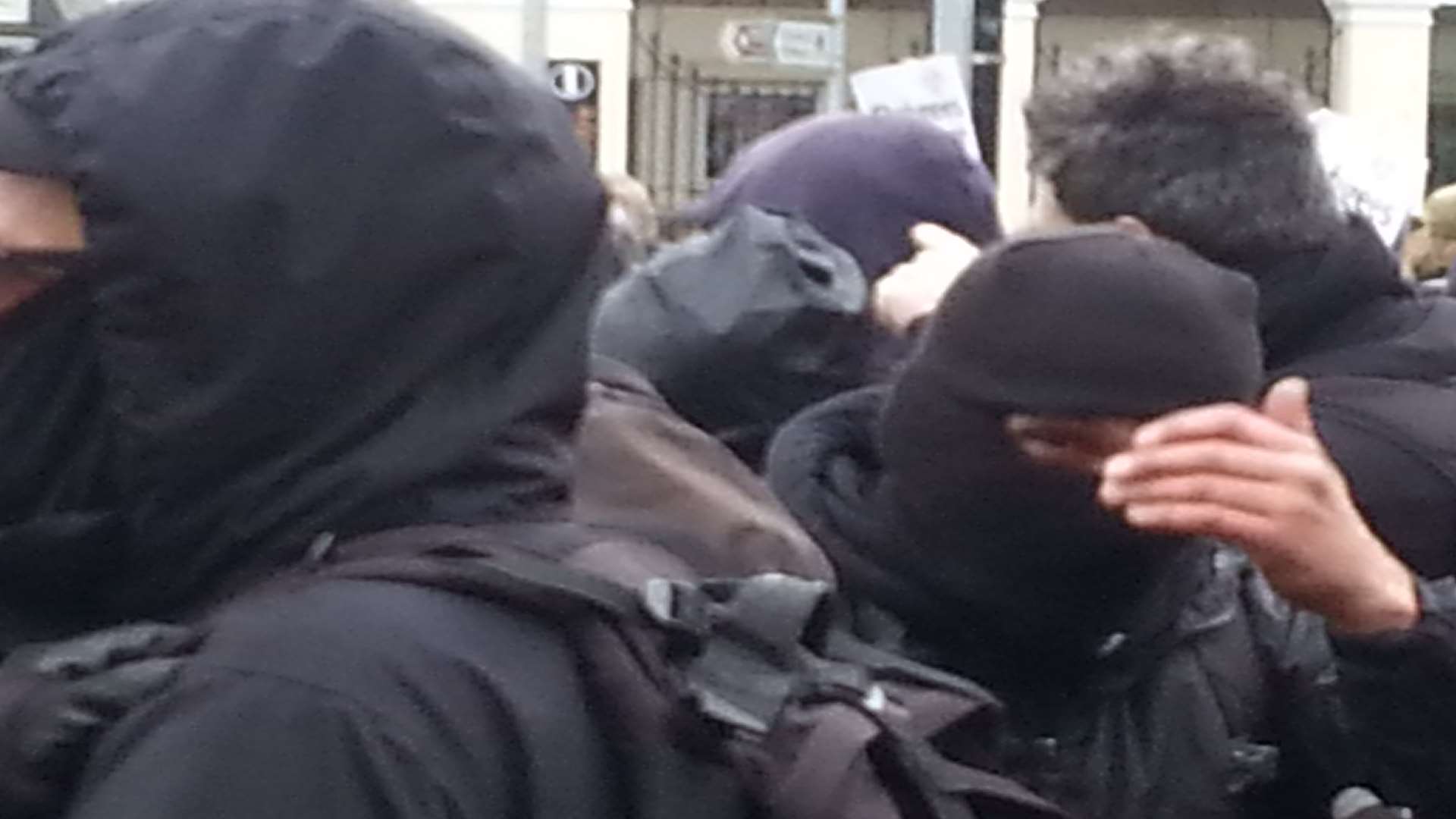 Masked men at anti-fascist rally