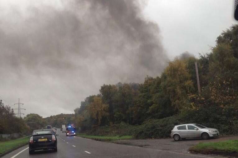 Smoke billows across the A2 from the breakers yard fire. Picture: Jessica Conroy
