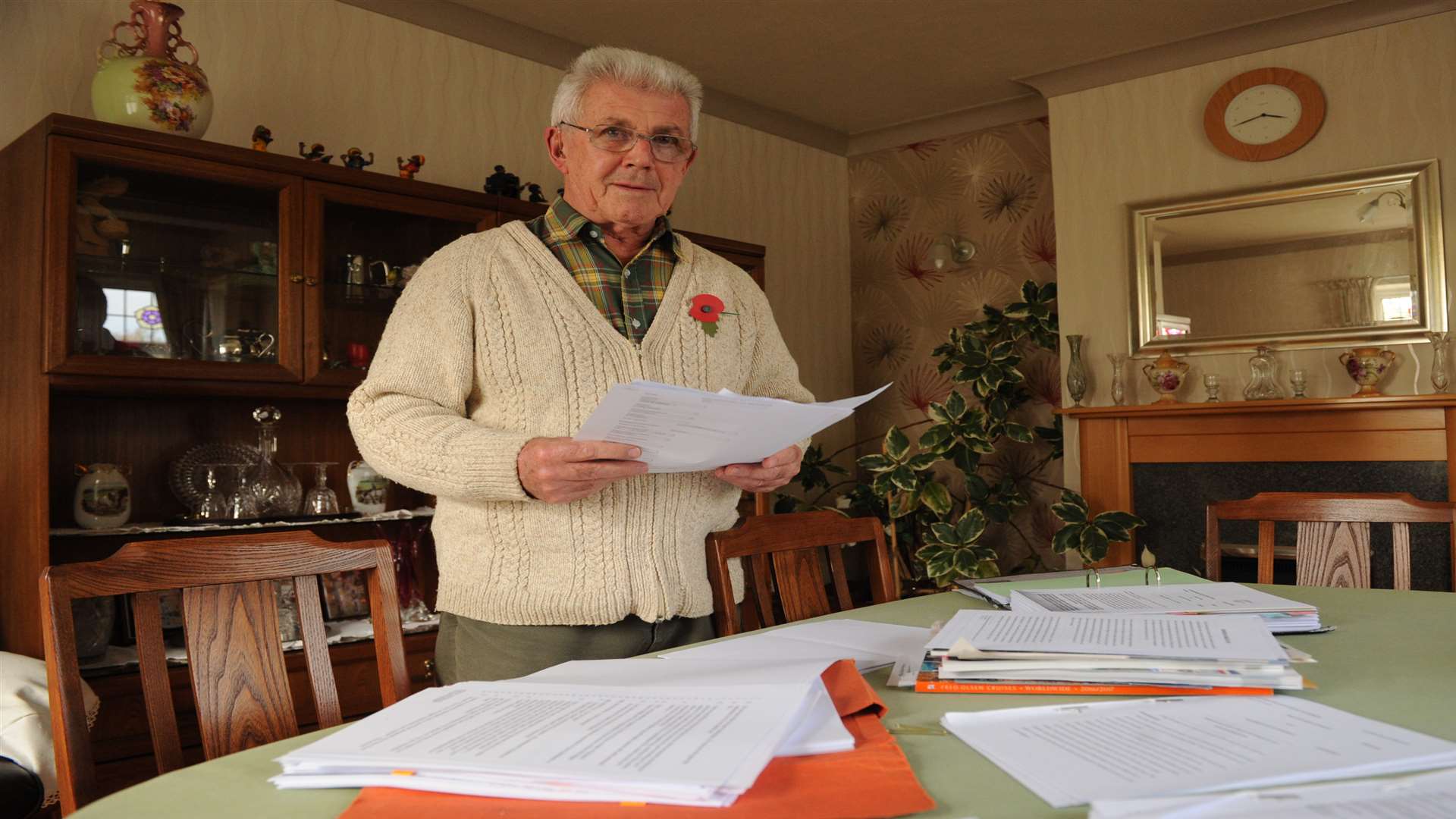 Leonard Debell at home, looking through solicitors paperwork. Picture: Steve Crispe