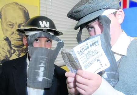 War time gas masks and ration books for Danny and Brandon, both 10. Picture: Barry Duffield.