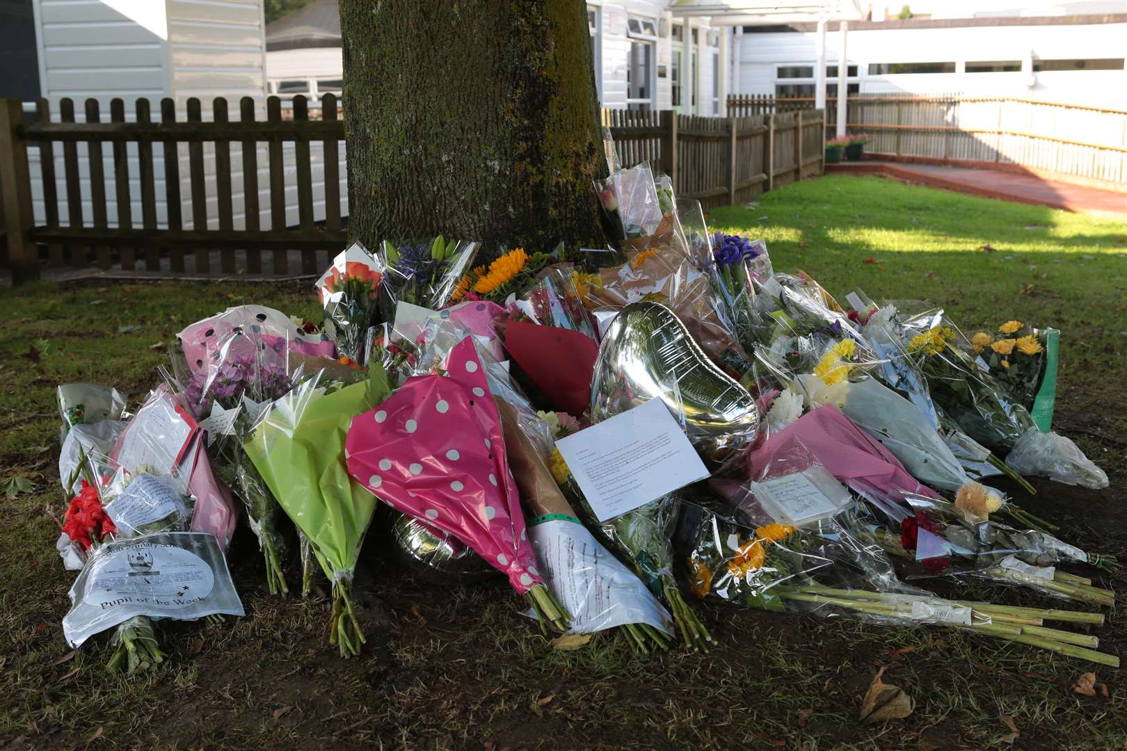 A mass of flowers have been placed at the school in tribute to head teacher Mark Geadah