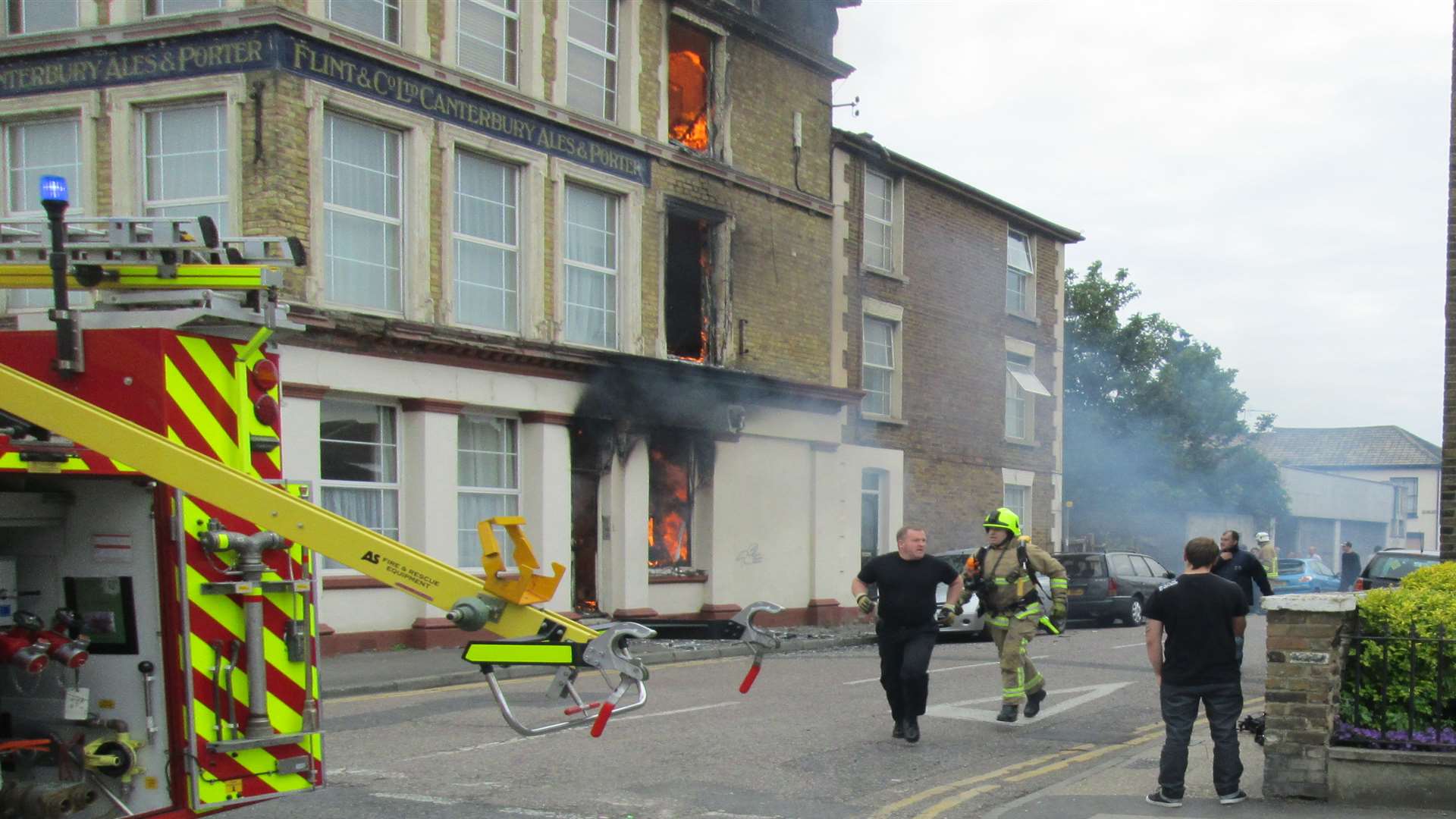 Flames lick a window frame of the Glass House building in Marine Parade, Sheerness
