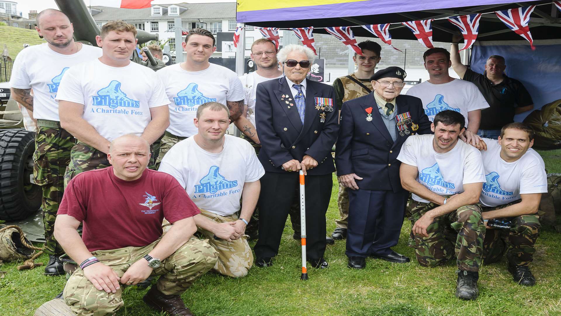 Fundraising runners the Pilgrim Bandits, in white shirts, at the end of their run from Strood to Gordon Promenade, Gravesend, with supporters and veterans. Veterans Philip Hubert, of Royal Navy Landing Craft, left, and Joe Hoadley, 49th Reconnaissance Corps.