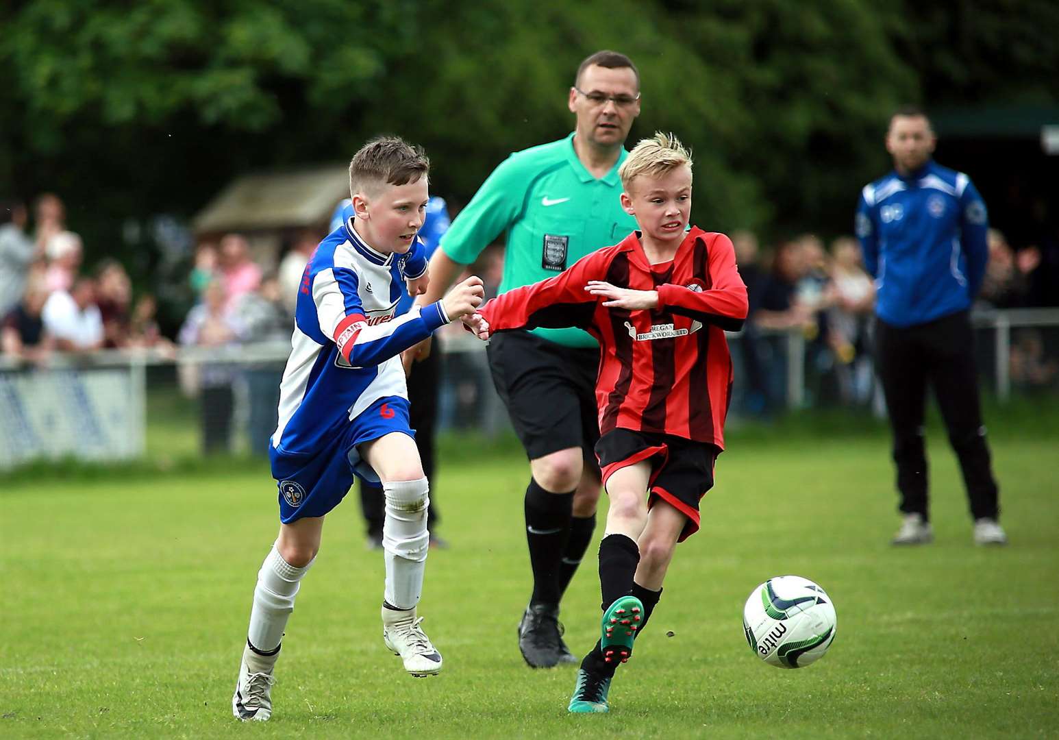 Meopham Colts (red and black stripes) take on Bredhurst Juniors in the Under-10 Trophy final Picture: Phil Lee