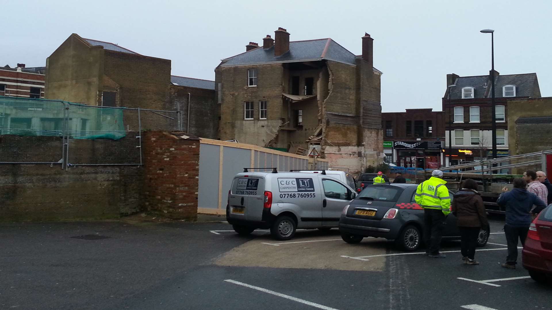 Passers-by look on at the scene of the collapse in Chatham