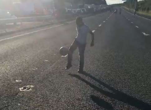 A youngster plays football on the M20 in July. Picture: @chantelisa on Twitter