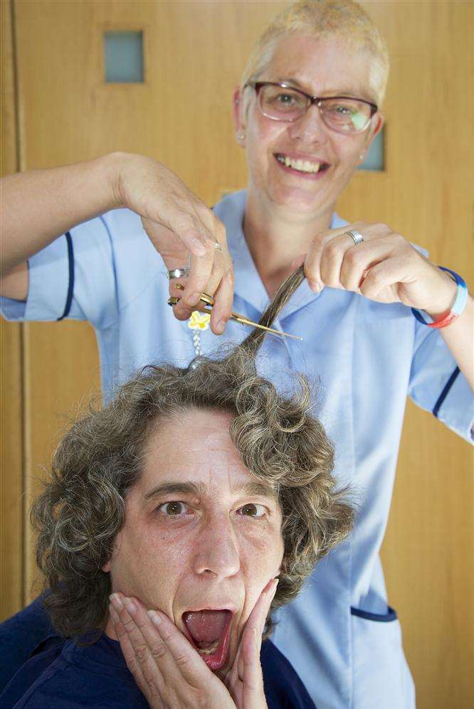 Palliative Care Nurse Lesley Dawson has her head shaved by Anita Moore at the Ellenor Lions Hospice