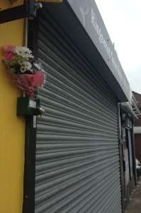 Flowers have been left outside Kingswood Tattoo Studio