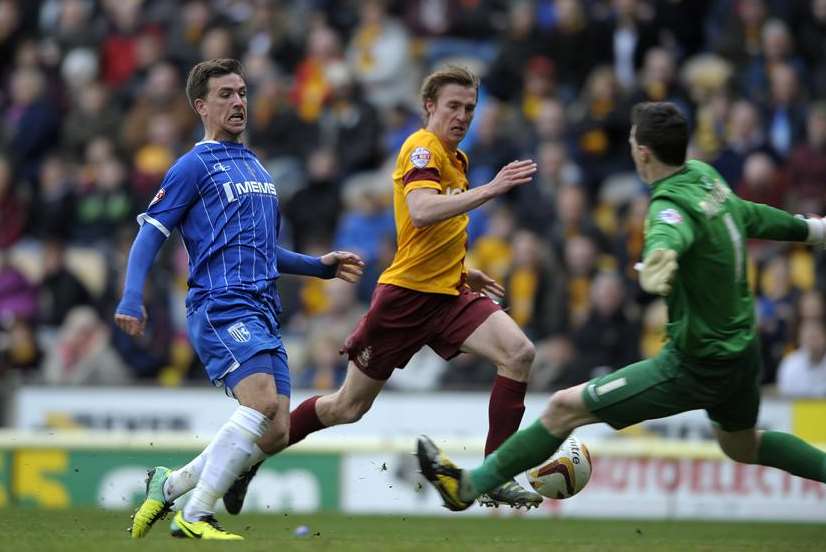 Cody McDonald beats Bradford keeper Jon McLaughlin to score the equaliser for Gillingham Picture: Barry Goodwin