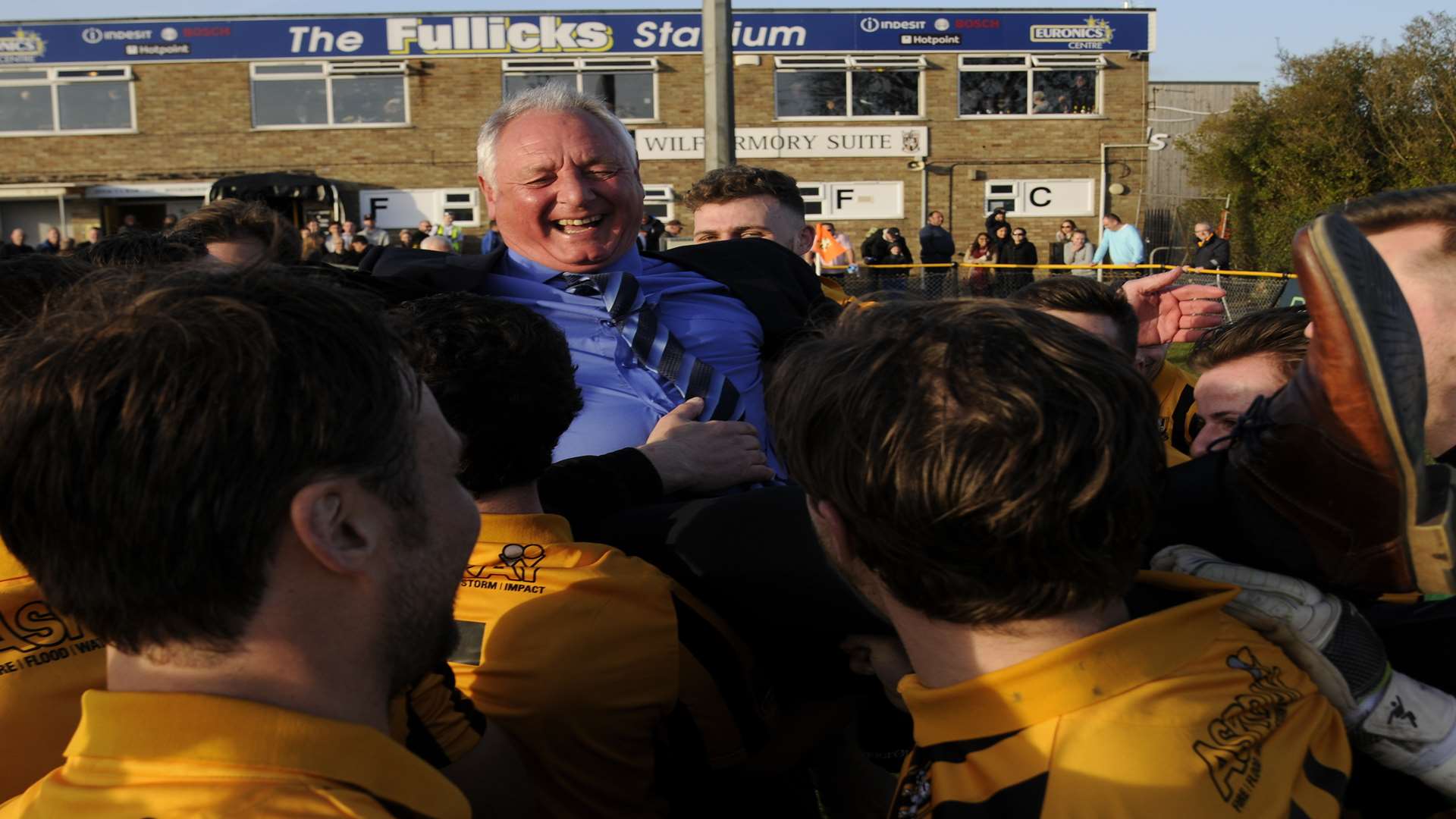Folkestone's players raise manager Neil Cugley aloft Picture: Gary Browne