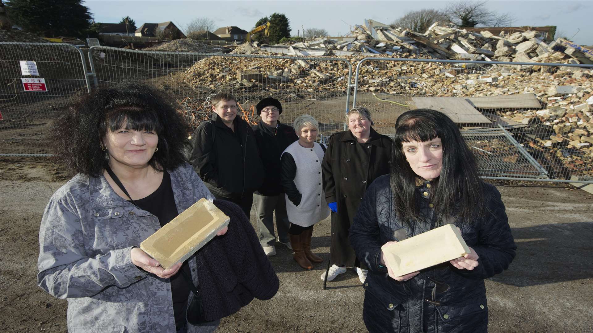 Linda Russell, left, and Sandra Russell, right, with bricks from the school, with from left, Michelle Milford, Jane Lee, Sharne Randall and Marie Burdett behind. Former pupils of the Chapter School
