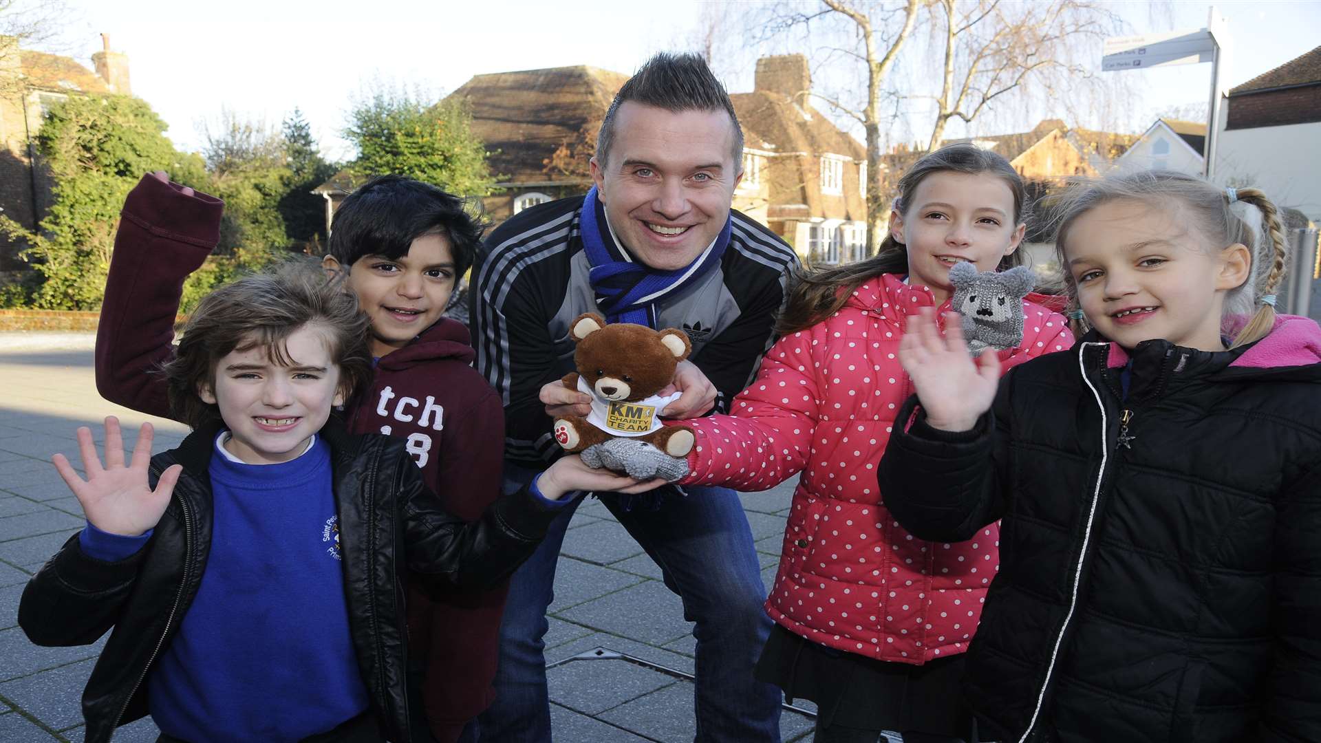 KM Charity Team mascot Ted the bear with Phil Gallagher (star of CBeebies' Mister Maker), Raphael, seven, Salem, six, Megan, seven, and Alice, seven, from St Peter's Methodist School in Canterbury.