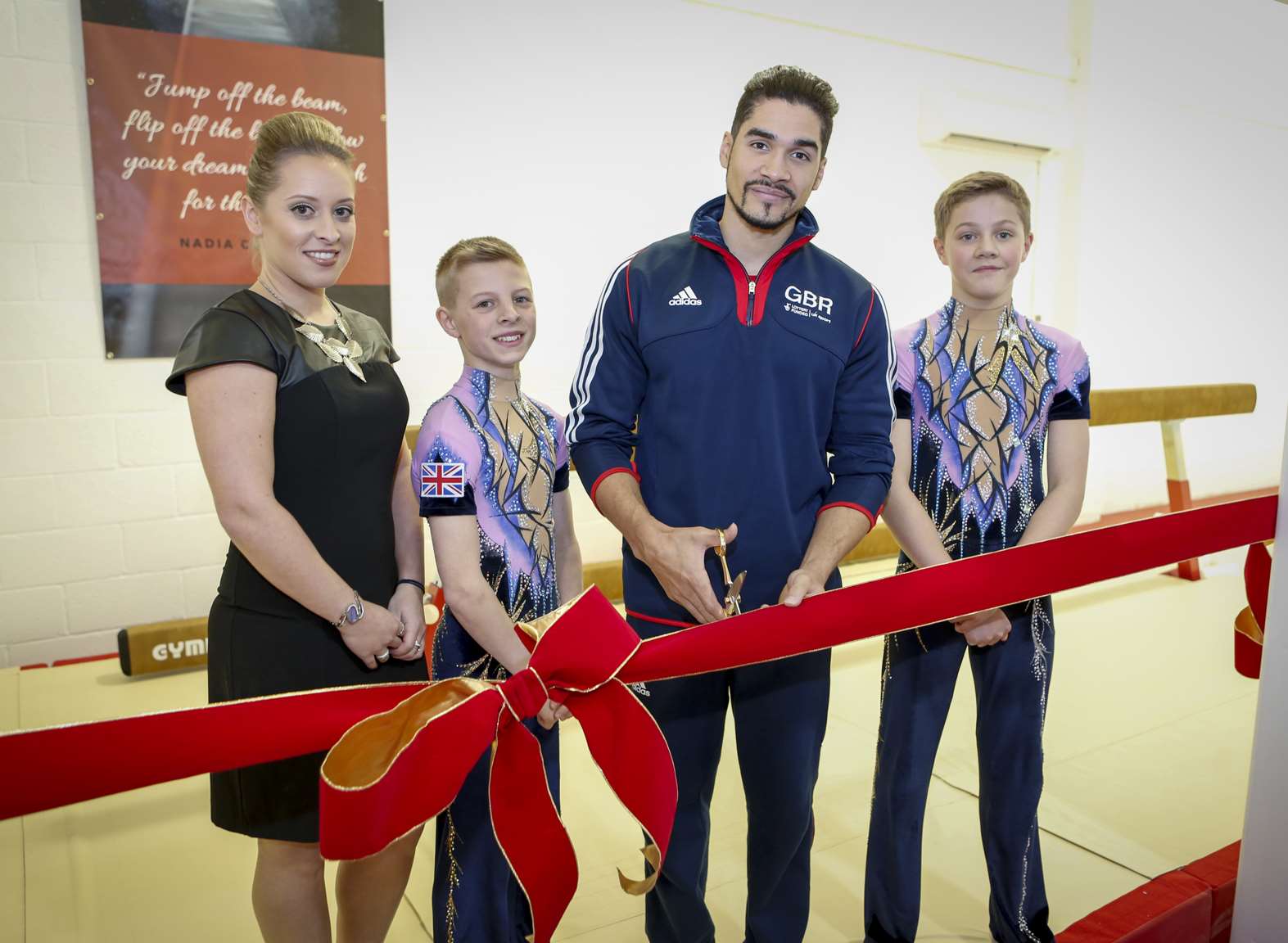 Louis Smith cuts the ribbon to open the new extension at the NDGA with the help of Hector Kinghorn (left) and Sam Large and watched by Amy Battell