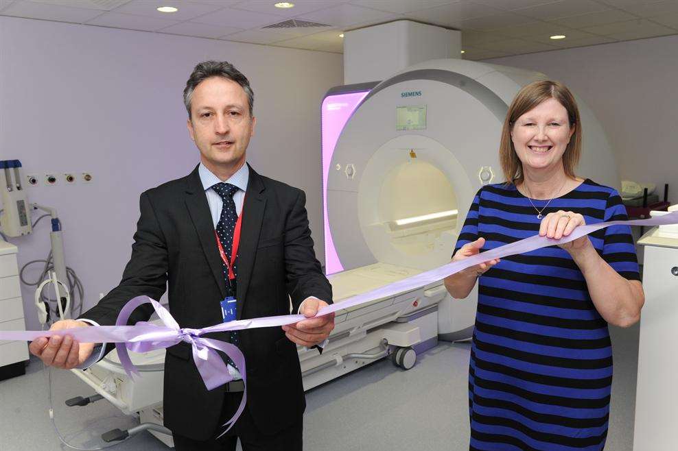 Stephen Giardina, head of MRI, cuts the ribbon with former patient Claire Riddle