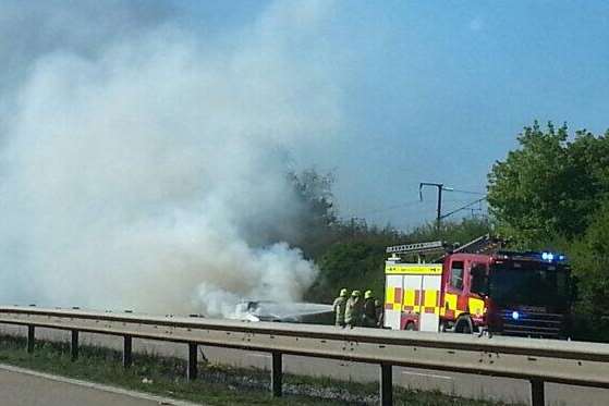 Firefighters tackle a blazing car on the M20. Picture: @Trevelloz