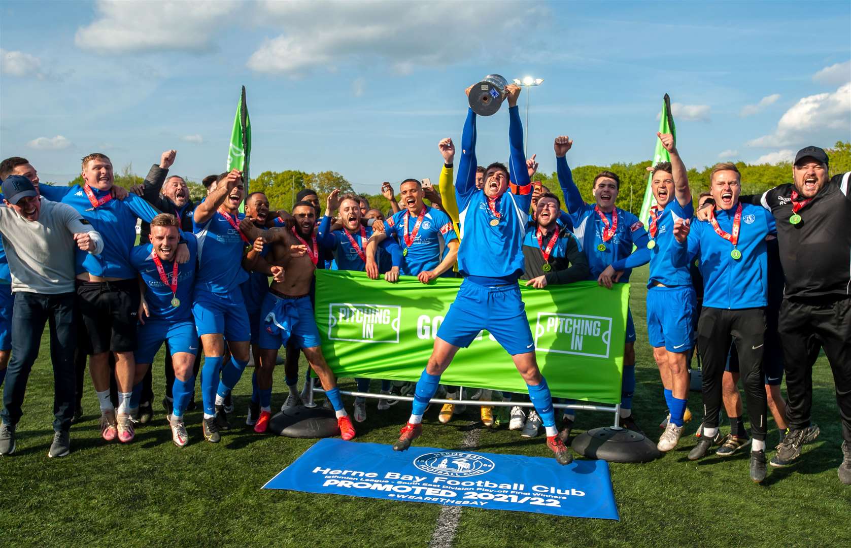 Herne Bay captain Laurence Harvey holds the trophy aloft after they win their Isthmian South East play-off final at Ashford. Picture: Ian Scammell